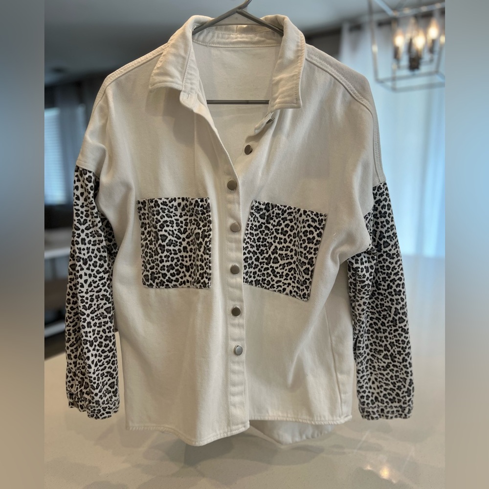 White jean jacket with cheetah pockets and sleeves